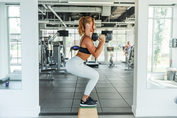 a woman lifting weights in a gym