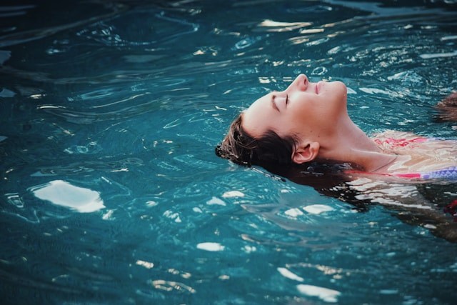 a woman swimming in a pool