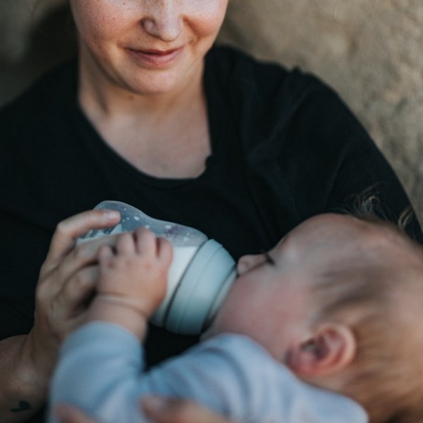 a woman holding a baby