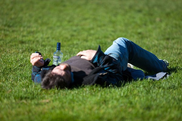 alcohol intoxicated man on grass