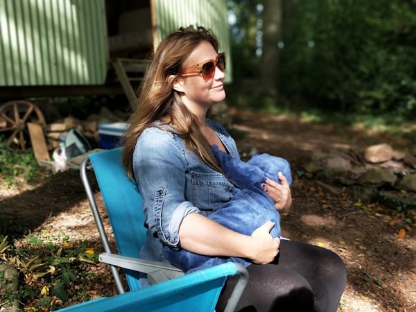 a woman sitting in a chair holding a baby