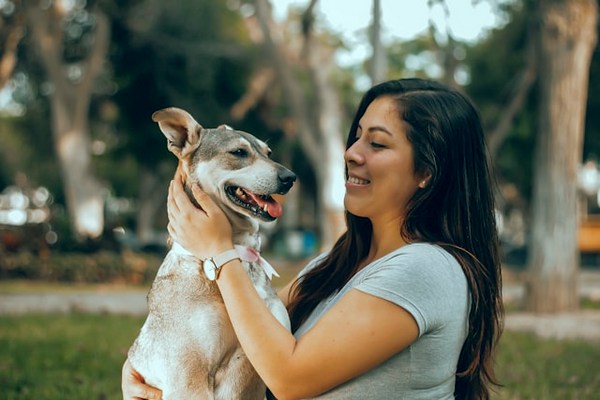 a woman holding a dog