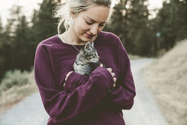 a woman holding a cat