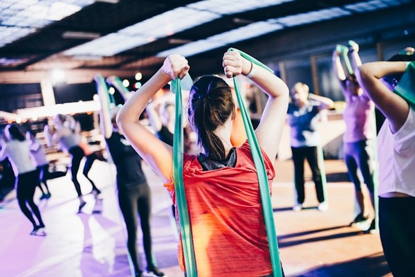 a woman holding a resistance band