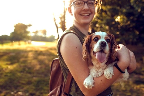 a woman holding a dog