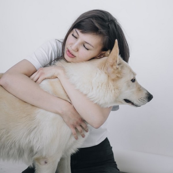 a woman hugging a dog