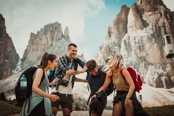 a group of people standing in front of a rocky mountain