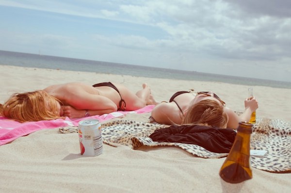 two women lying on the beach